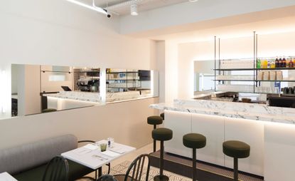 Cafe / bar with white walls and white marble sides