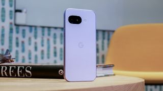 Google Pixel 9a propped up on its own on table.