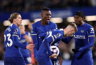 Noni Madueke and Nicolas Jackson of Chelsea argue with Cole Palmer about taking the penalty during the Premier League match between Chelsea FC and Everton FC at Stamford Bridge on April 15, 2024 in London, England. (Photo by Catherine Ivill - AMA/Getty Images)