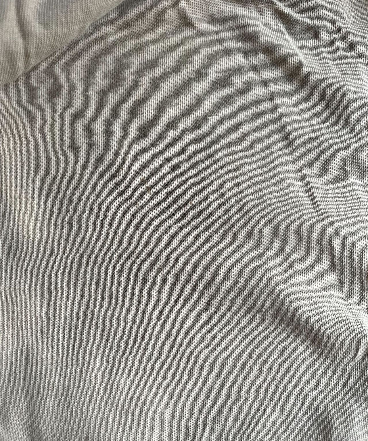 Some old, small blood stains on a beige top