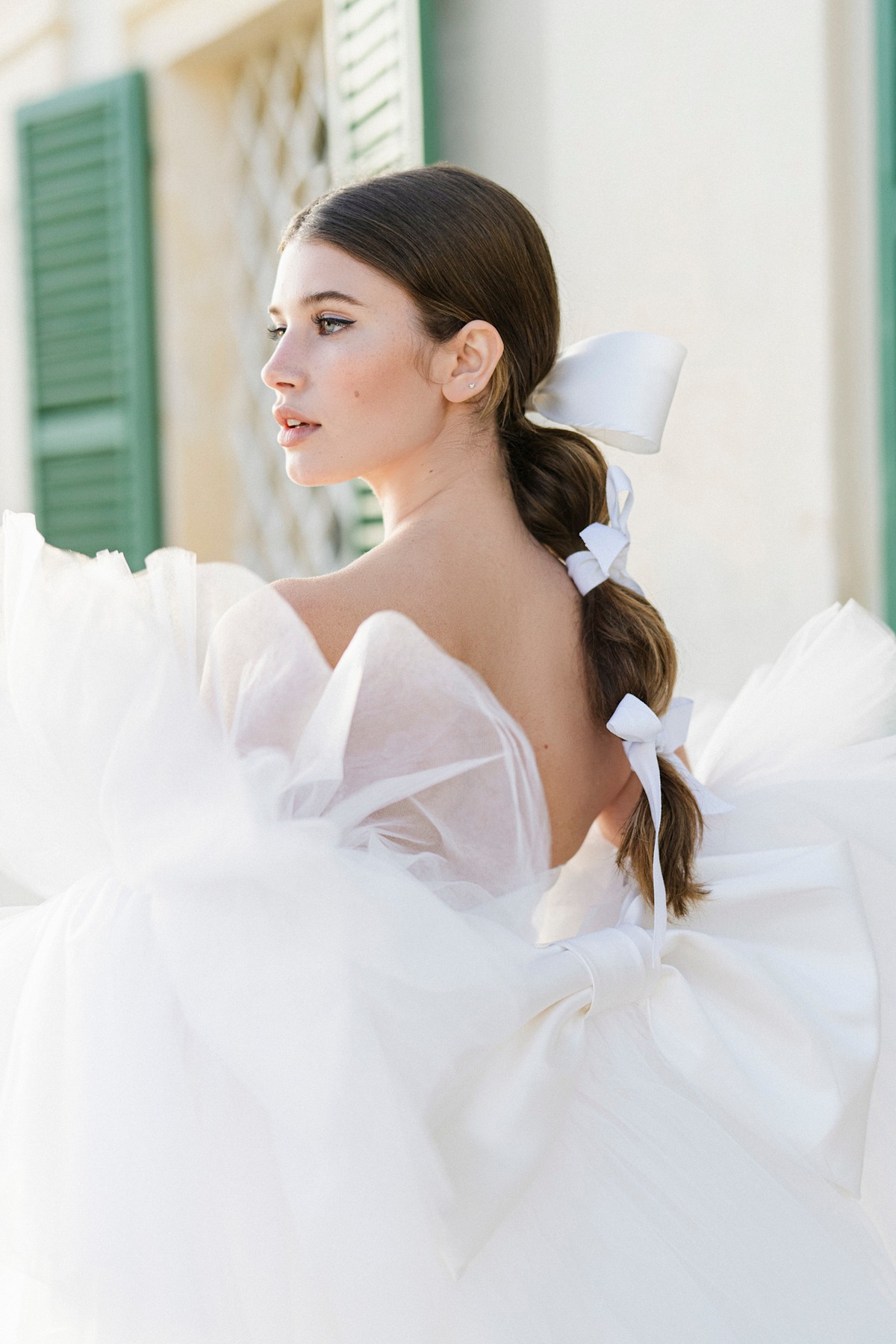 A model showing off a bubble braid wedding hairstyle.