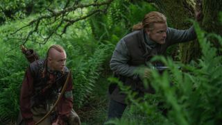Young Ian and Jamie Fraser stalking through the woods in Outlander season 7 episode 6