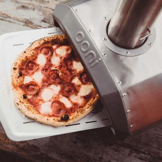 Ooni Karu 12 Pizza Oven with a cooked pizza