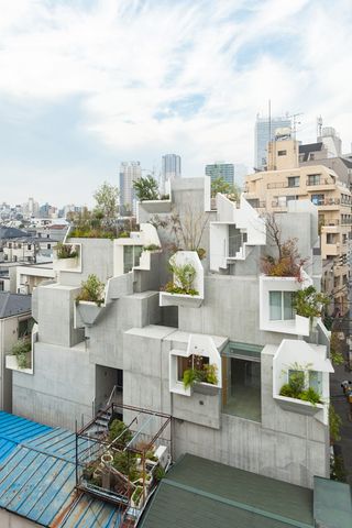 Abstract shaped concrete building with green spaces