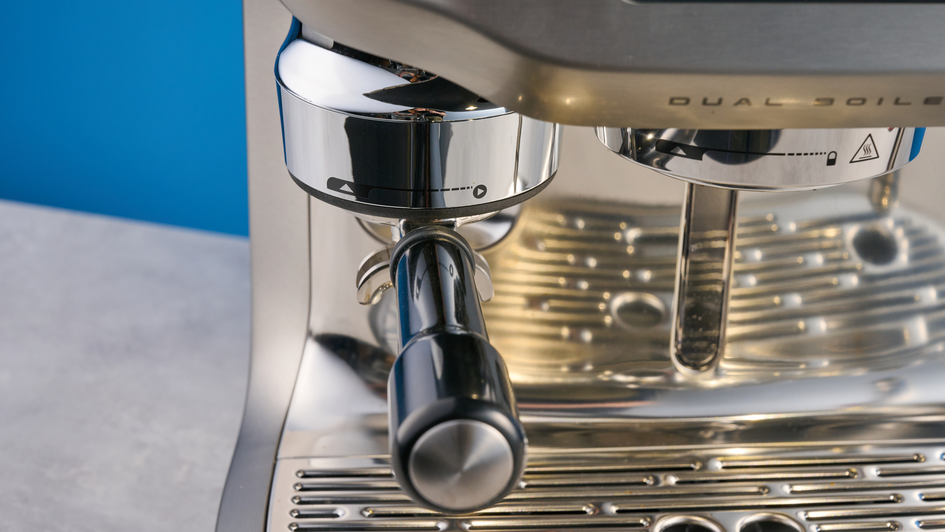 the breville oracle dual boiler / sage oracle dual boiler in stainless steel, showing its touchscreen, steam wand, built in grinder, and espresso shots