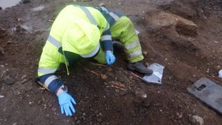 An archaeologist working in a medieval cemetery in Carrickfergus, Northern Ireland.