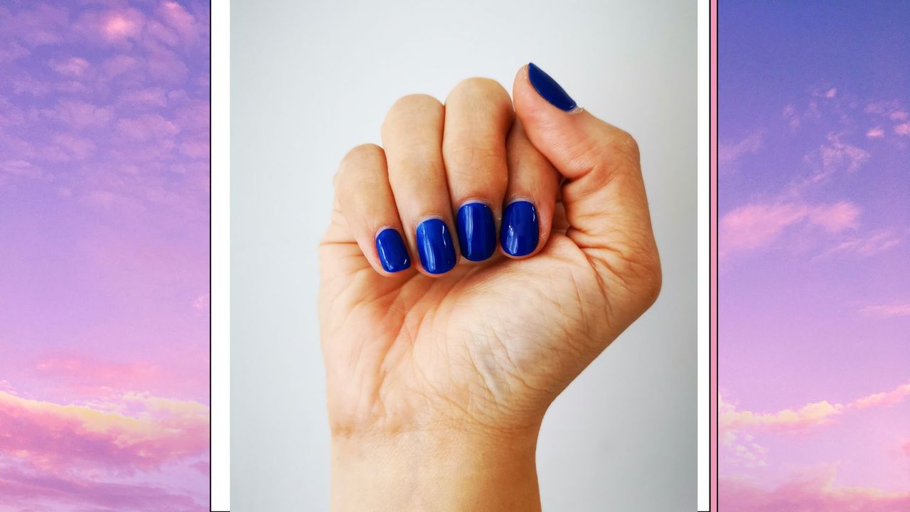 Woman&#039;s hand and nails with blue manicure