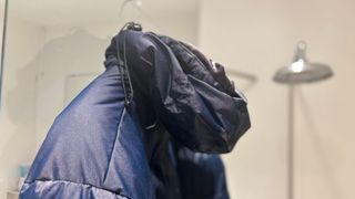 A waterproof jacket drying in the shower
