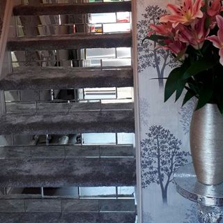 staircase with white designed wall and flower pot