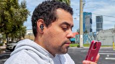 Man wearing Skullcandy Dime 3 earbuds outside