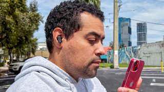 Reviewer Alex Bracetti wearing Skullcandy Dime 3 earbuds outside