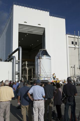 The Orion crew module, on top of a service module, is moved from an operations and checkout building at NASA's Kennedy Space Center on Sept. 11 to a nearby payload hazardous servicing facility. The spacecraft is being readied for a December test flight.