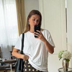 French influencer Anne Laure Mais wearing the With Jean Penny Skirt with a white T-shirt