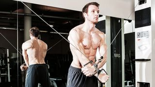 Man does cable crossover chest exercise