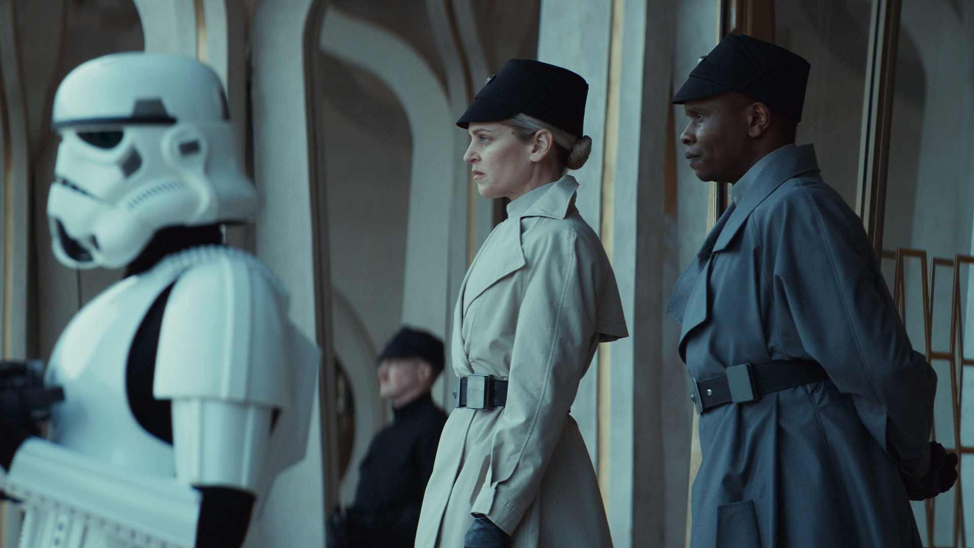 Dedra Meero standing with another ISB officer by a stormtrooper in Andor season 2