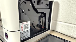 Service door opened on KitchenAid Fully Automatic Espresso Machine KF6 to show brewing group