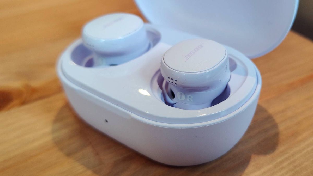 The Bose QuietComfort Earbuds 2024 on a wooden table.