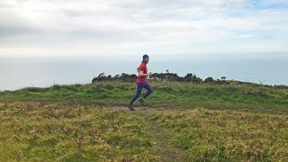Person trail running in leggings and T-shirt