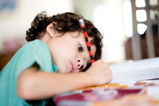 Young boy doing homework.