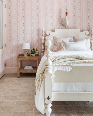 girl's bedroom with pink wallpaper, white bedroom, white swan decoration and rattan bedside table