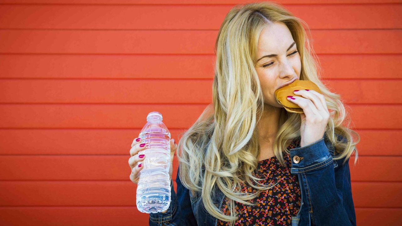 Woman Eating Cheeseburger