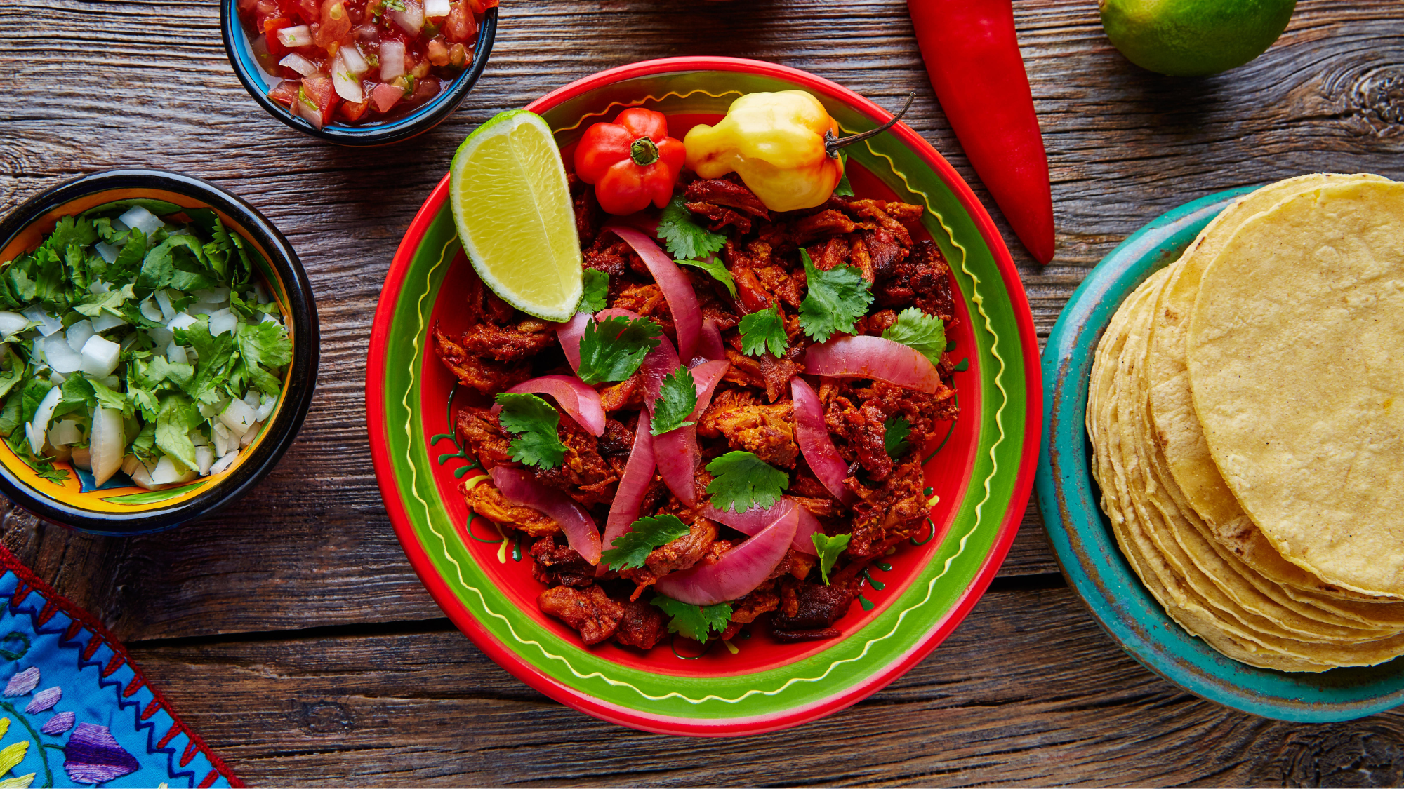 Cochinita Pibil Mexican platillo food with red onion and coriander