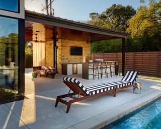 outdoor pool patio with cover, tv, and outdoor grill