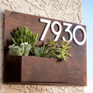 rough wall with house number planter