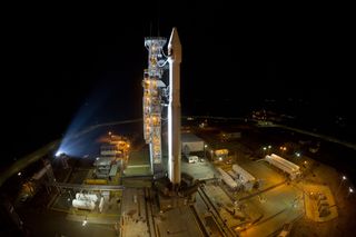 A United Launch Alliance Atlas V rocket stands poised to launch a classified U.S. spy satellite, NROL-55, into orbit for the National Reconnaissance Office. The rocket will also launch 13 tiny cubesats when it lifts off from California's Vandenberg Air Fo