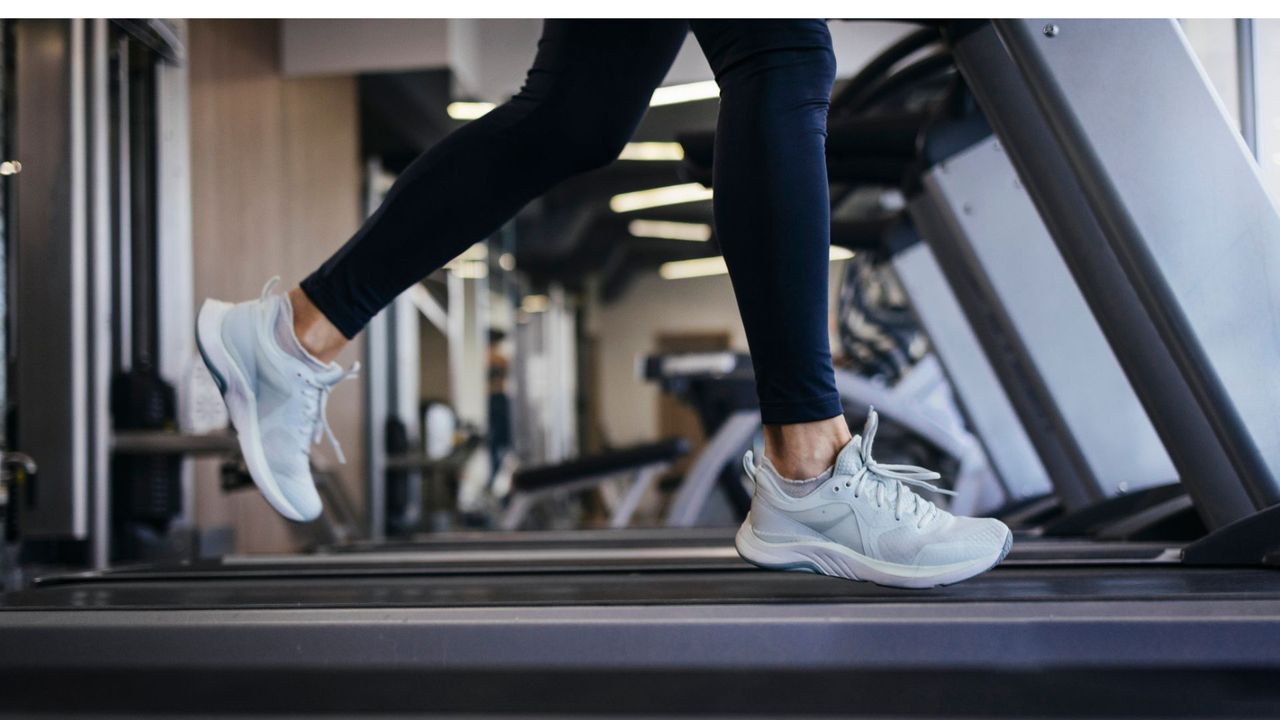 Woman&#039;s legs running Couch to 5km on a treadmill at the gym