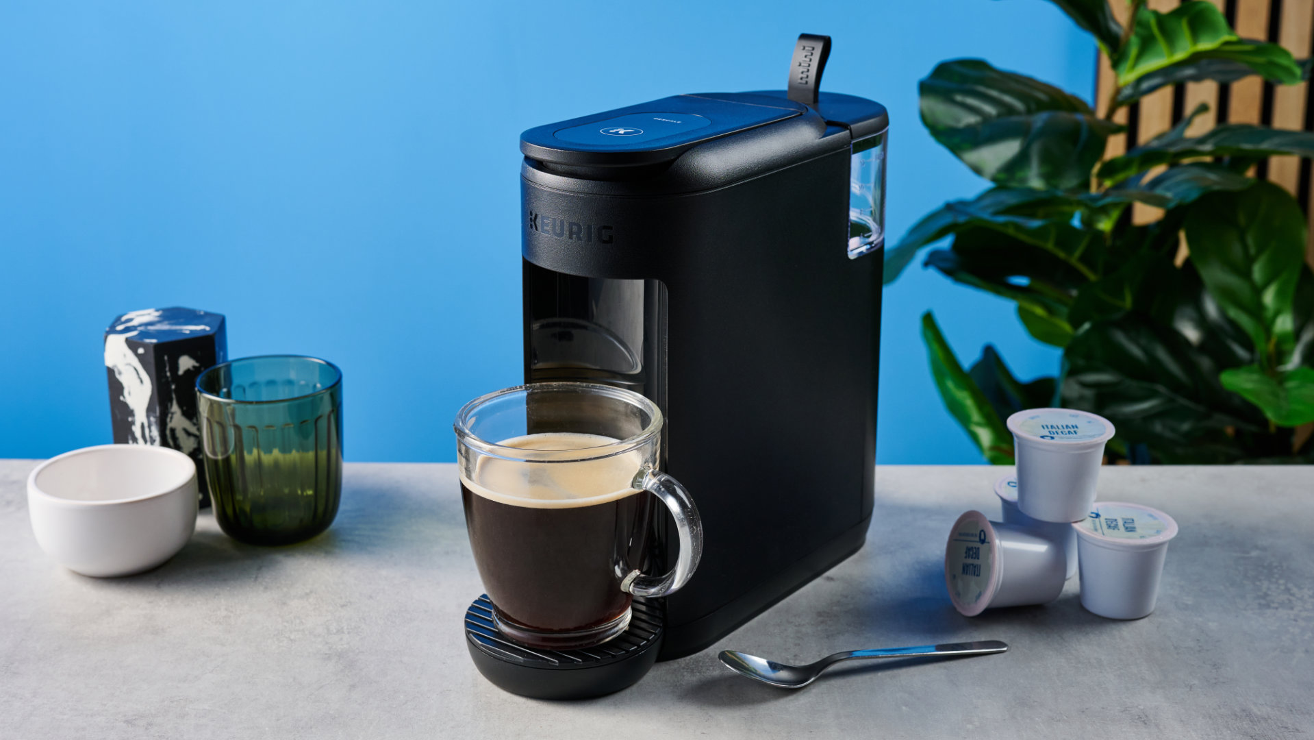 the keurig k-mini mate coffee maker photographed with the blue tom's guide background