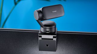 a photograph of a small grey 4K webcam with a gimbal and PTZ functionality