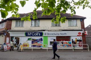 A photo of a McColl's shop with a Post Office sign