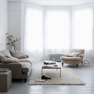 living area with grey sofa and wooden floor
