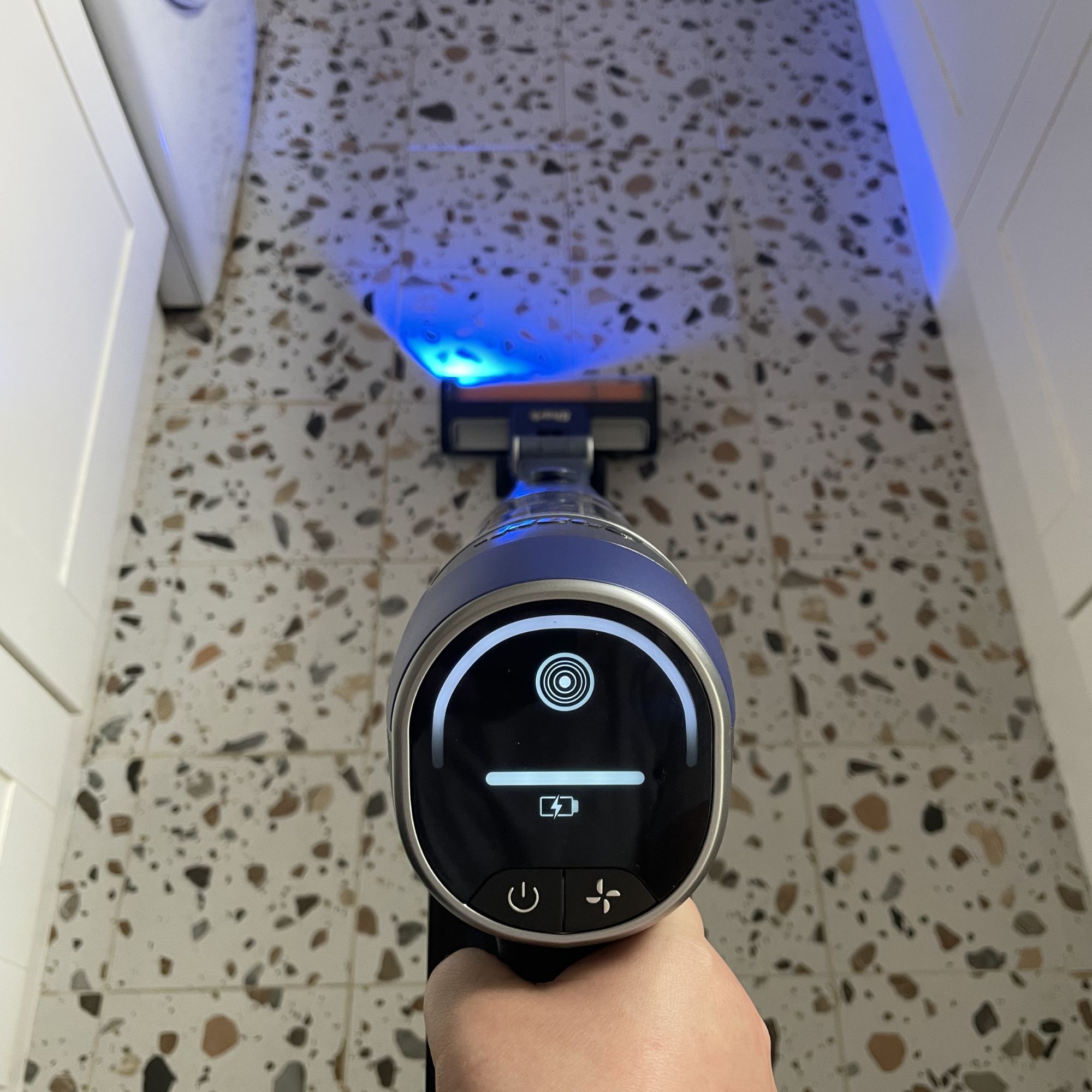 Shark PowerDetect Speed Clean and Empty being used to clean terrazzo tiled floor in a kitchen