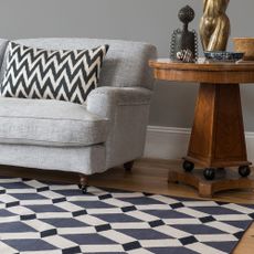 armchair with grey wall and wooden flooring