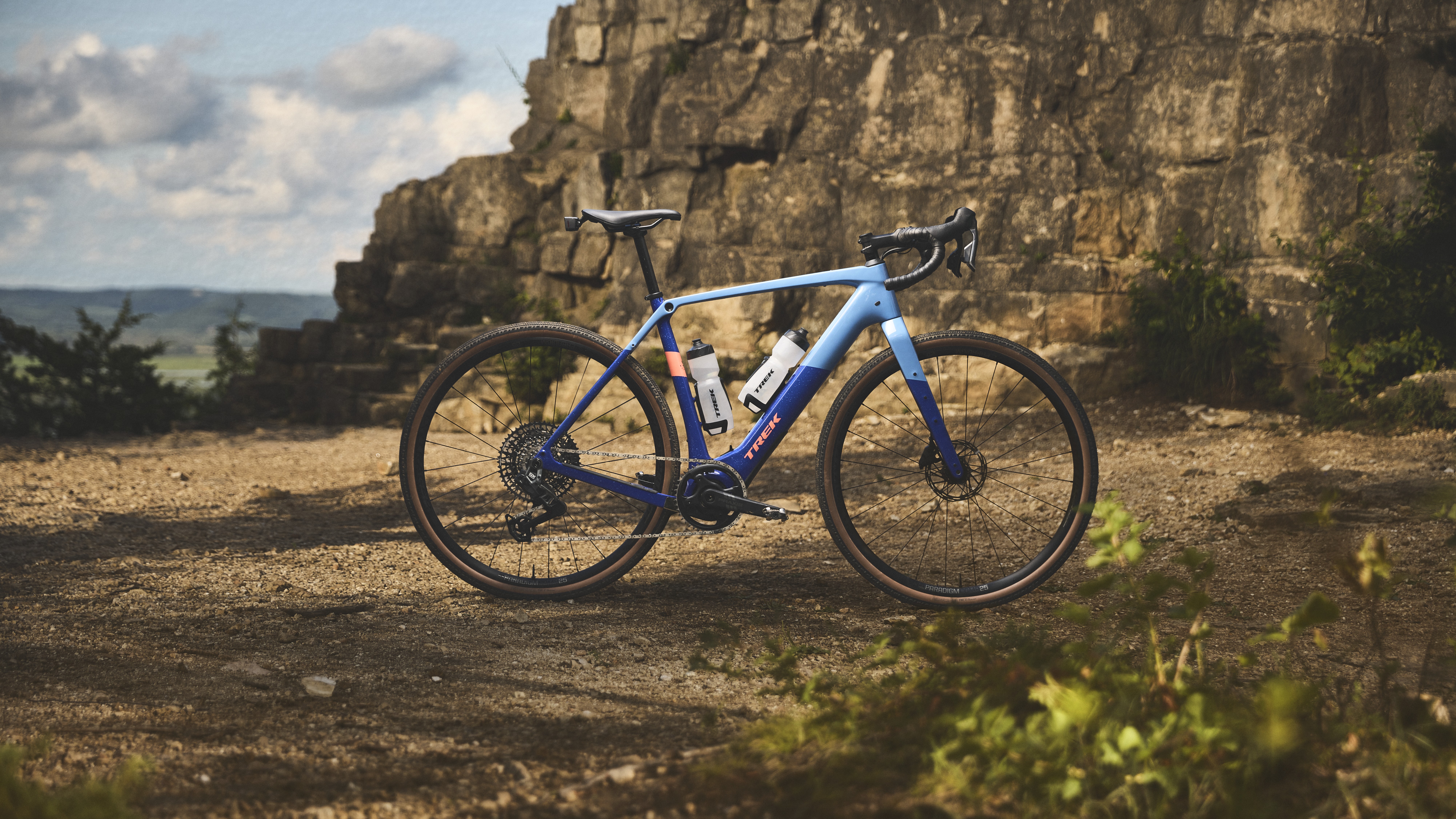 A Trek Checkpoint+ in front of a rocky cliff