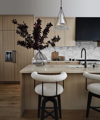 kitchen island with vase and branches by K Interiors