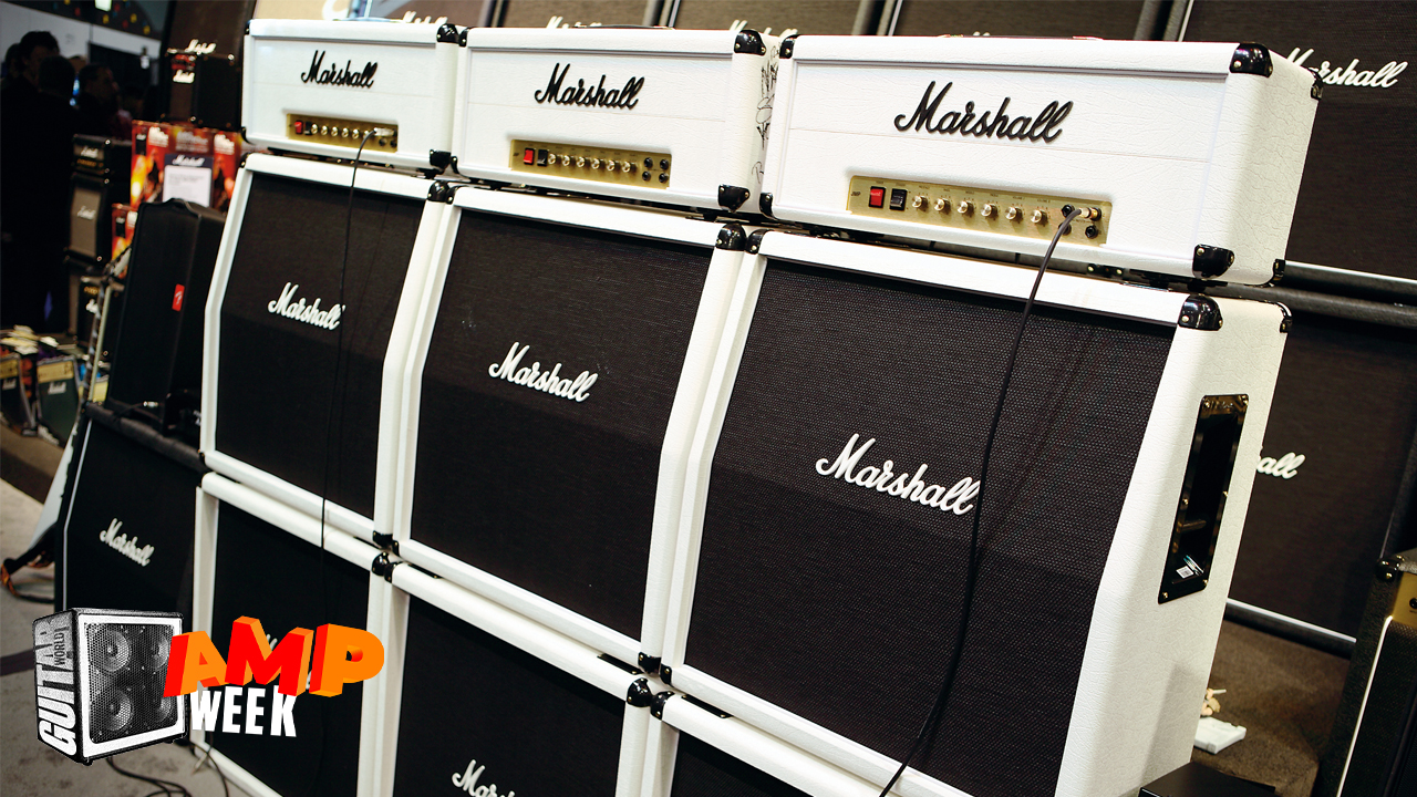 A stack of white Marshall guitar amp heads and matching cabinets