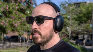 Wearing Sonos Ace headphones outside with sunglasses.