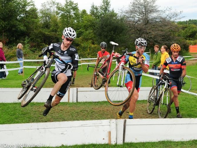 Shawn Milne (Keough Cyclocross) and Adam Myerson running the barriers on lap one