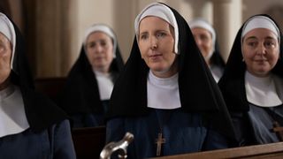 Sister Hilda in a habit watching a church service