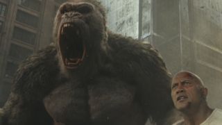 Dwayne Johnson stands with a large gorilla in Rampage