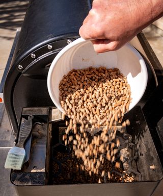 Adding pellets into a pellet grill