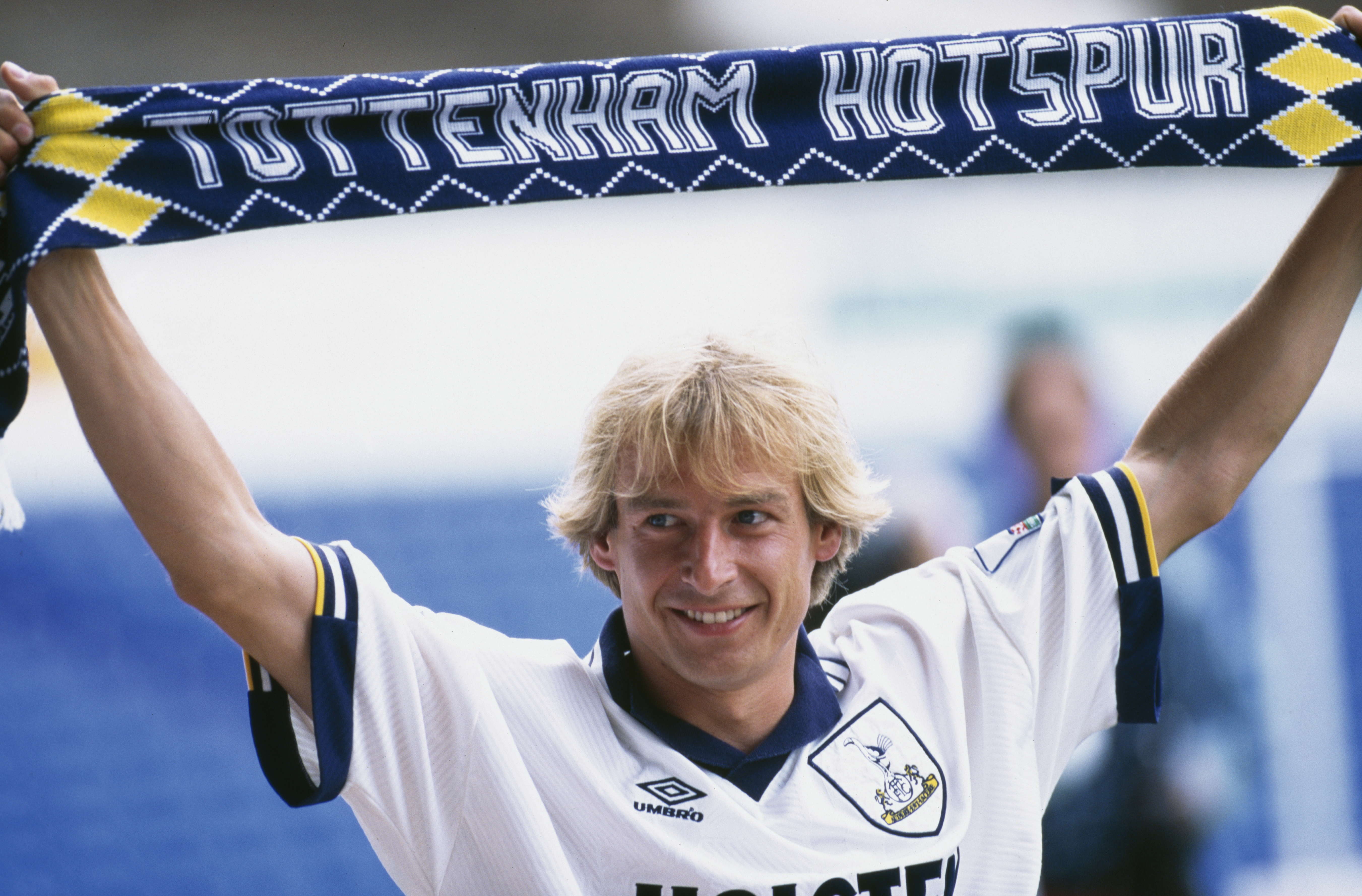 Jurgen Klinsmann holds up a Tottenham scarf at his unveiling in August 1994.