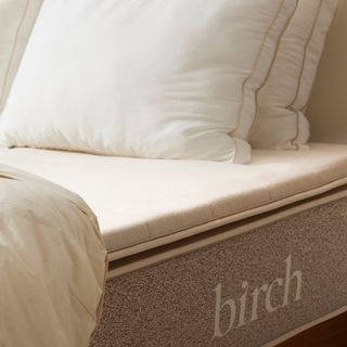 Birch Plush Organic Mattress Topper on a bed.
