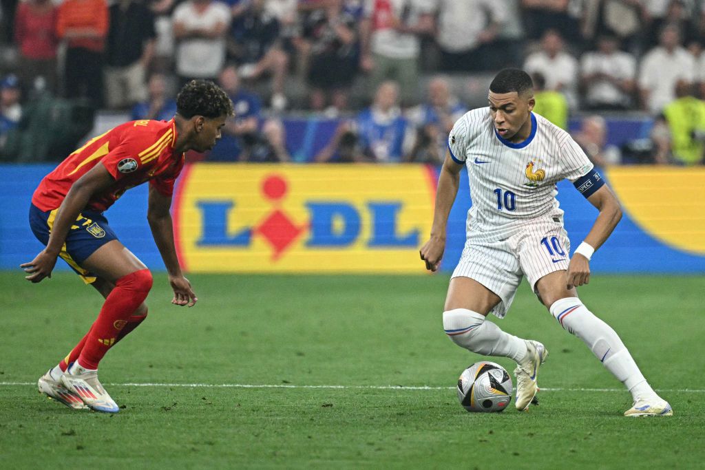 Kylian Mbappe of France takes on Lamine Yamal of Spain