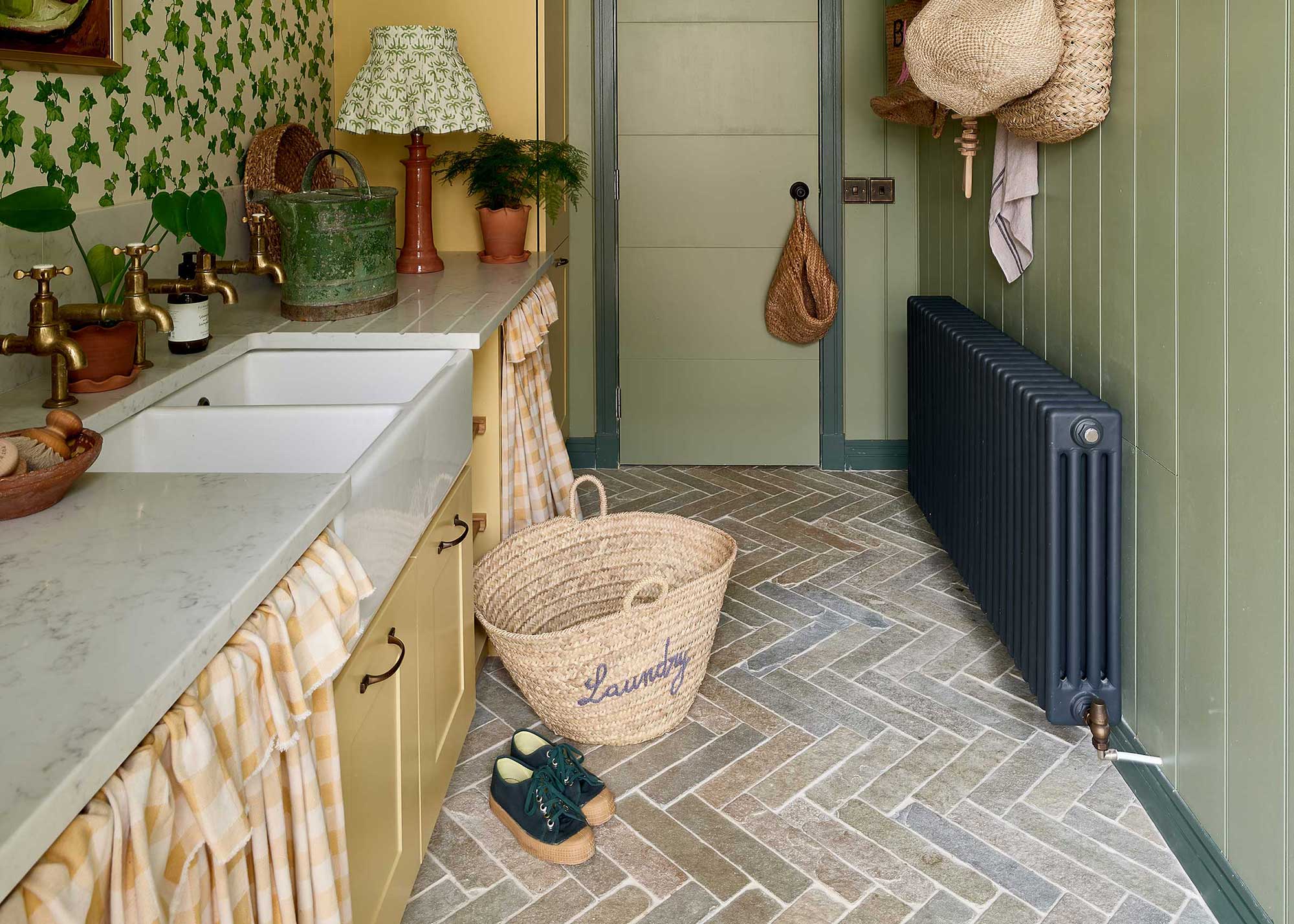 rustic yellow laundry room with herringbone brick flooring