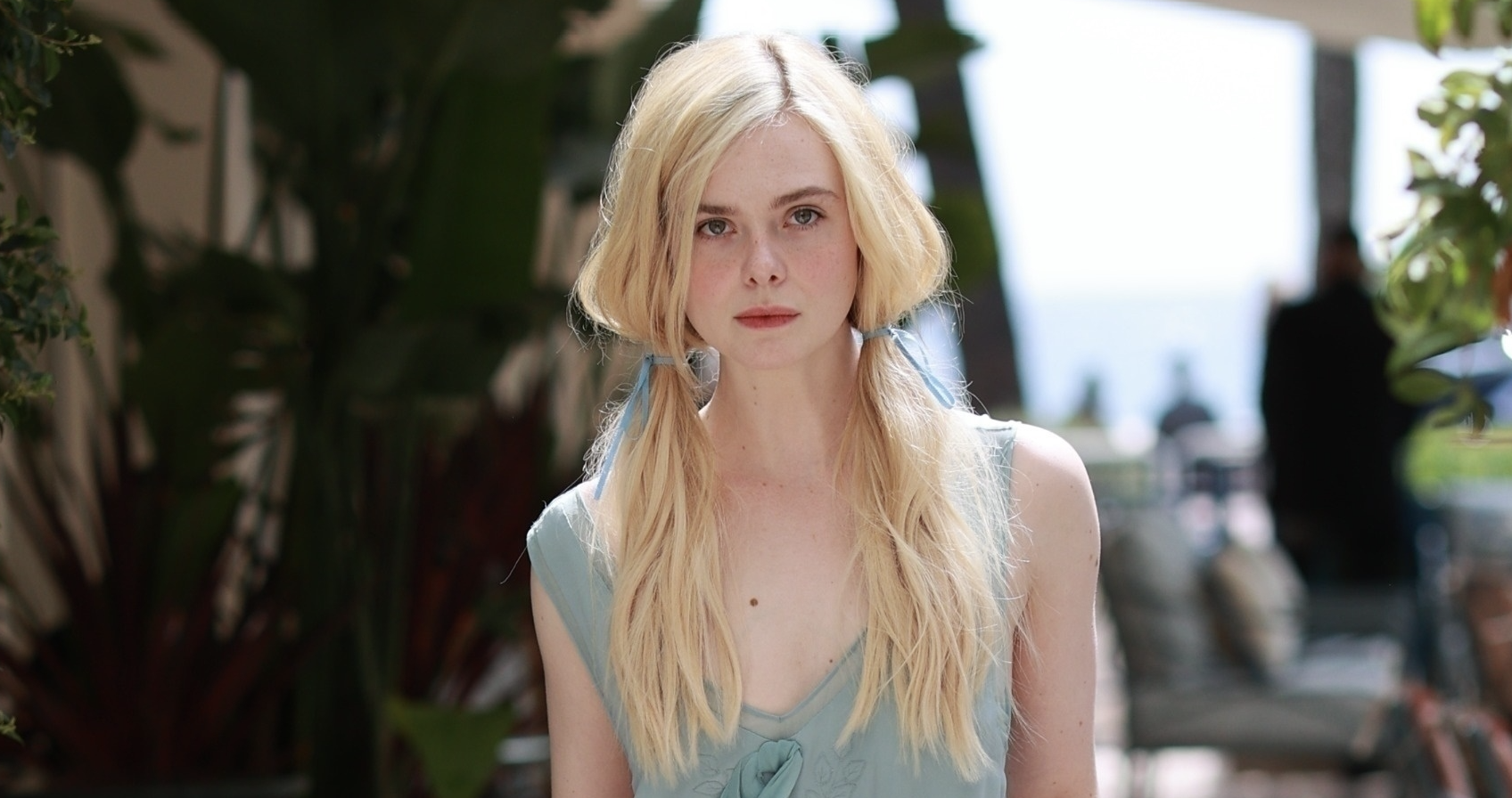 Elle Fanning getting ready to head out to a premiere in Cannes in a blue dress