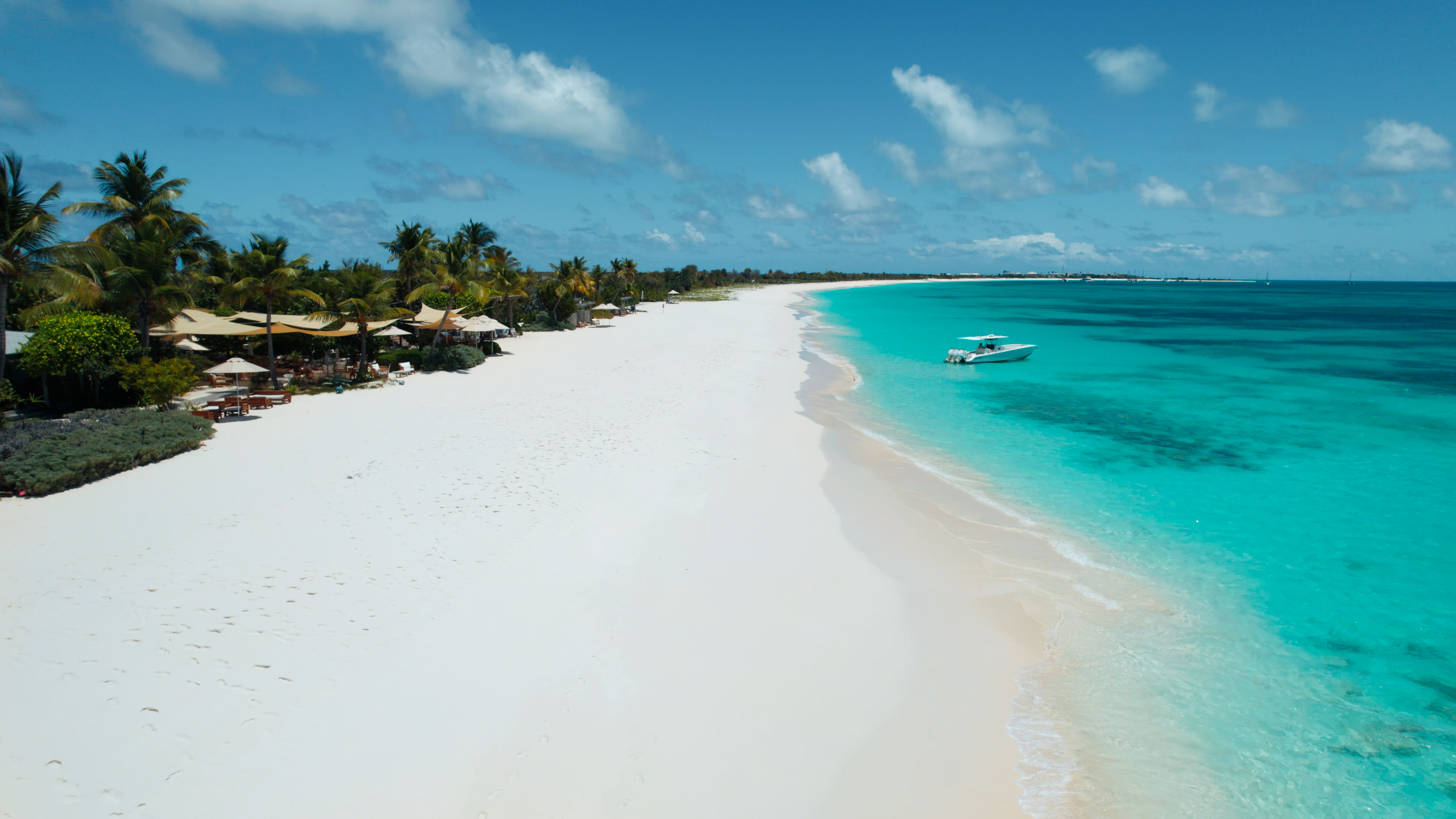 white sand and blue green waters in a Barbuda beach